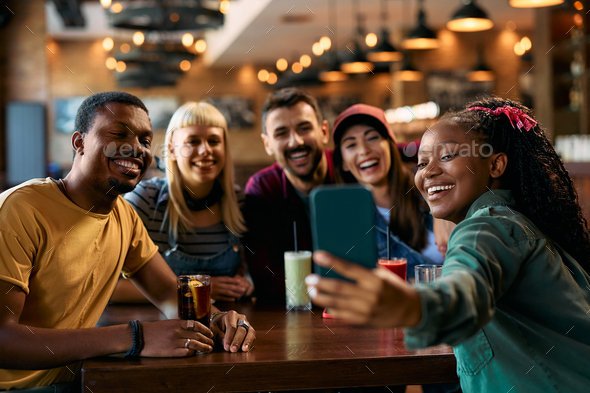 Multiracial Group Of Happy Friends Taking Selfie In A Pub Stock Photo